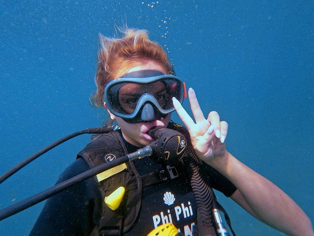 phi-phi-cabana-diving-try-scuba-diving-c A lady diver smiling and showing how excited she is while scuba diving