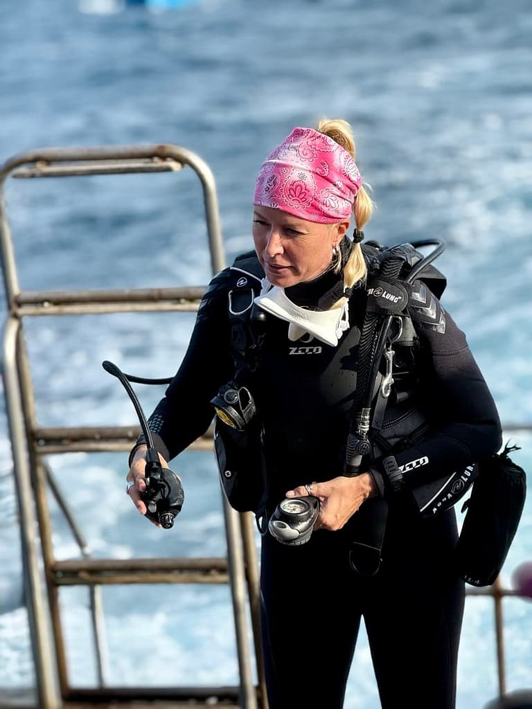 A high experienced diving instructor holding her buonancy gear right before dive into the water of Phi Phi Island 