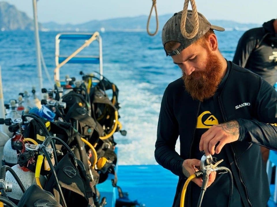 Scuba diving instructor preparing the gear right before diving.